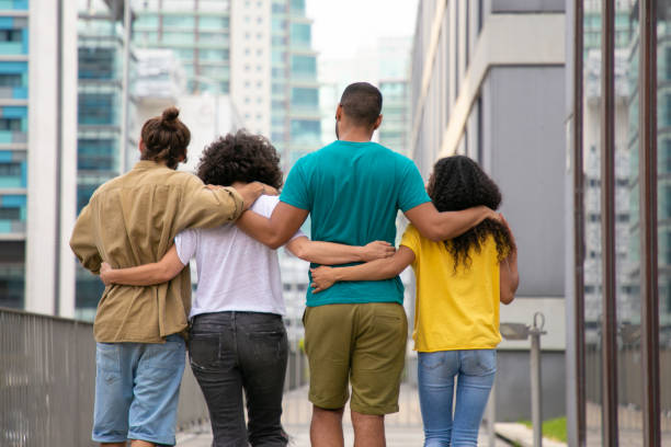 istock Back view of young people walking outdoors 1187797497