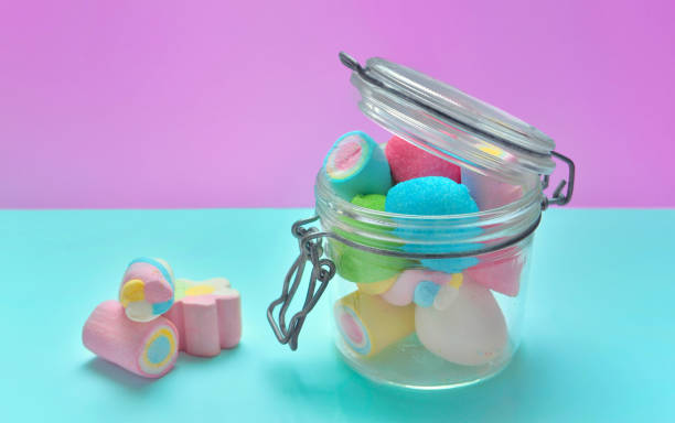 istock colorful marshmallows in a glass jar on blue and pink background 1187798449