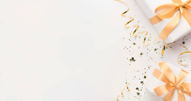 istock White gift boxes wrapped in gold bow on white background 1187799880