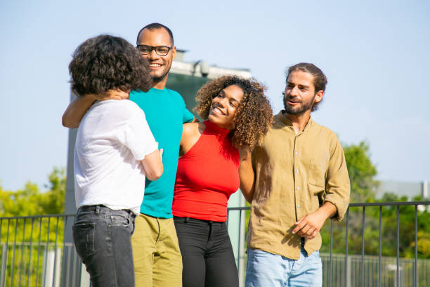 istock Young friends embracing and walking outdoors 1187800575