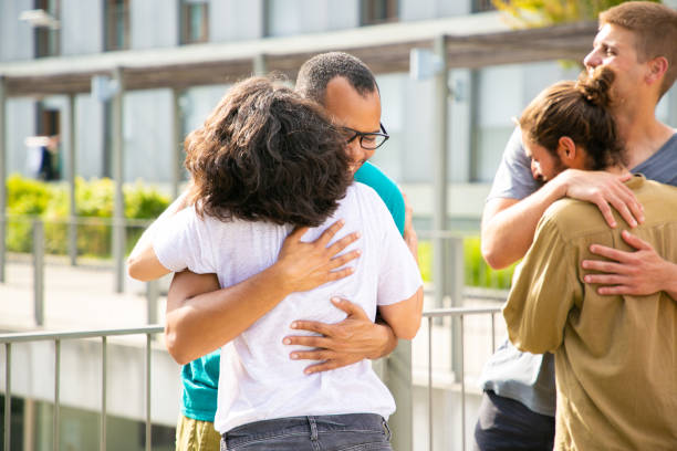 istock Cheerful friends hugging outdoors 1187801864