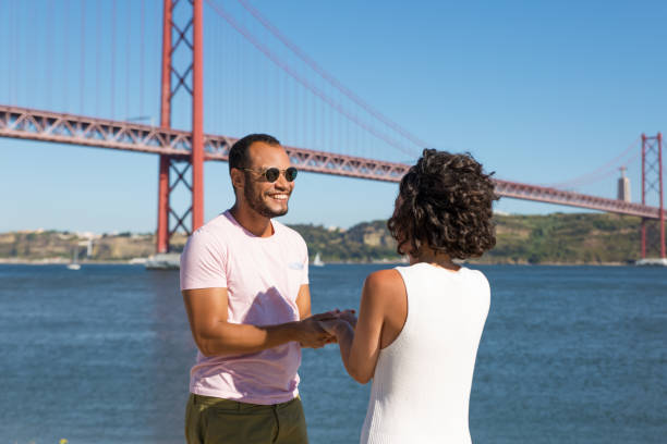 istock Cheerful young friends holding hands near river 1187803195