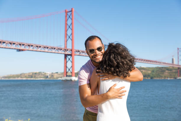 istock Happy young couple hugging near river 1187804812
