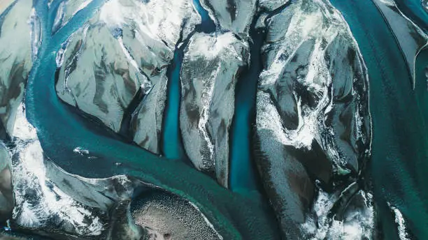 Drone photo of beautiful blue glacial rivers during wintertime in Iceland