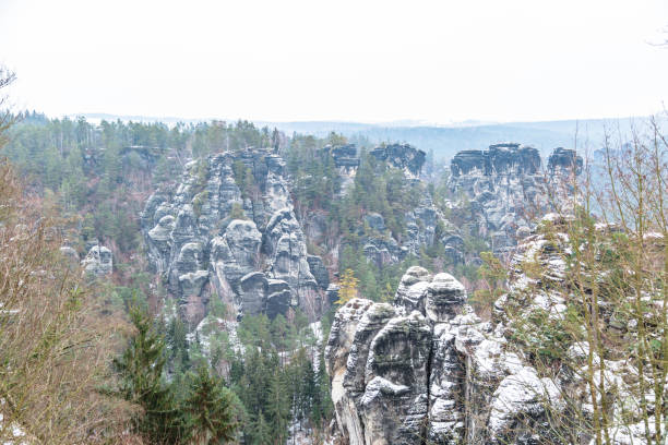 istock Snowy mountains with trees in Saxon Switzerland 1187807410