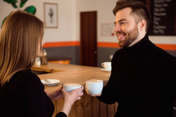 istock Beautiful Woman And Handsome Man Drinking Coffee While Spending Time In Coffee Shop. 1187807462