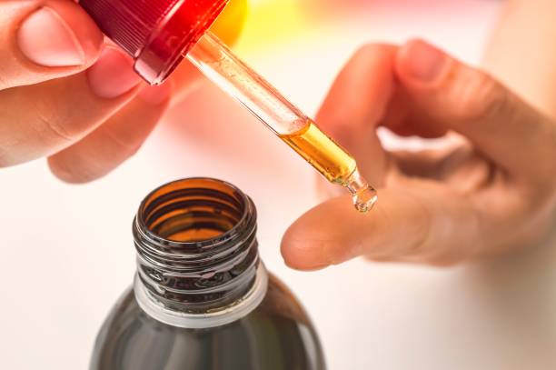 istock Collagen serum for face is dropping on female finger 1187807496