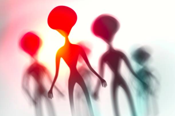 istock Silhouettes of spooky aliens and bright light on behind them 1187807529