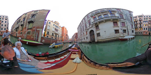 VR on a gondola in Venice, Italy. There is a 90 year old woman looking at the camera as the gondolier negotiates the narrow Rio Dei Greci canal.