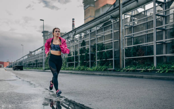 istock Sportswoman running in an industrial zone 1187808892