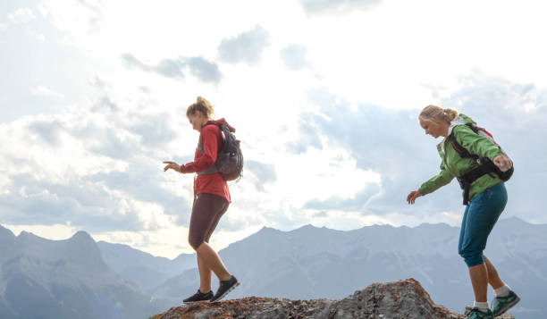 istock Female mountaineers traverse mountain summit 1187808944