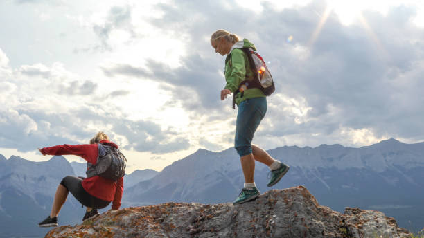 istock Female mountaineers traverse mountain summit 1187808993