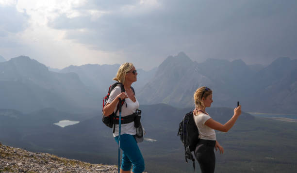 istock Female hikers ascend to mountain summit 1187808996