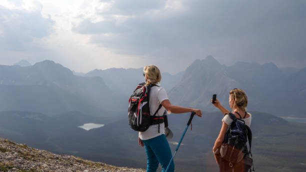 istock Female hikers ascend to mountain summit 1187809012