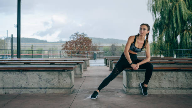 istock Sportswoman posing sitting on a bench 1187809013