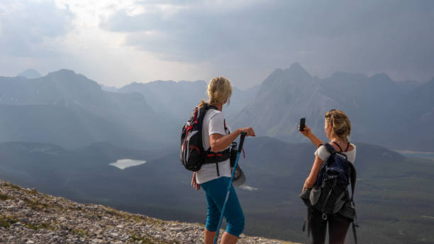 istock Female hikers ascend to mountain summit 1187809025