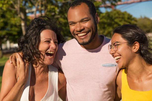 istock Happy friends laughing in park 1187809267