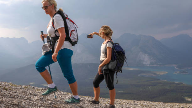 istock Female hikers ascend to mountain summit 1187809969