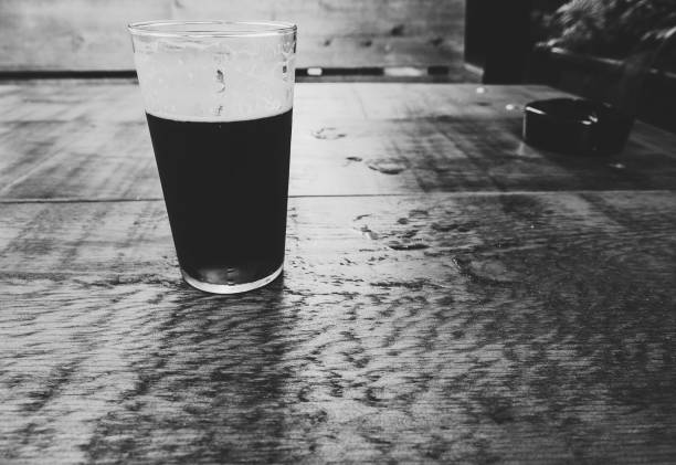 british ale beer pint and ashtray in black and white