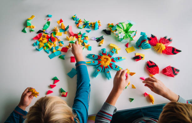 istock kids making origami crafts with paper, learning 1187813084