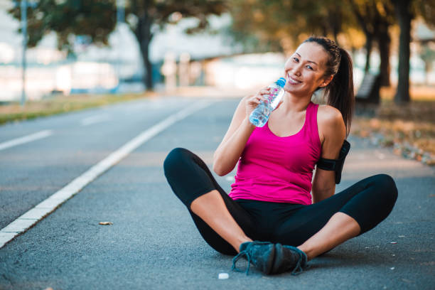 istock Young lady relaxing after exercising 1187813134