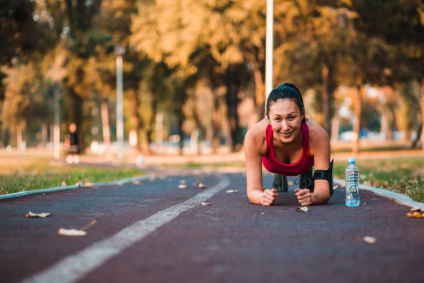 istock Charismatic woman doing planks 1187813154