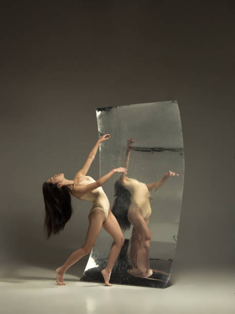 istock Young and stylish modern ballet dancer on brown background 1187813661