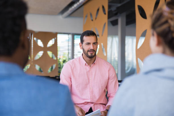 istock Friendly confident business coach speaking before audience 1187813973