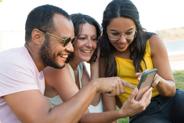 istock Happy multiethnic friends using smartphone 1187814364