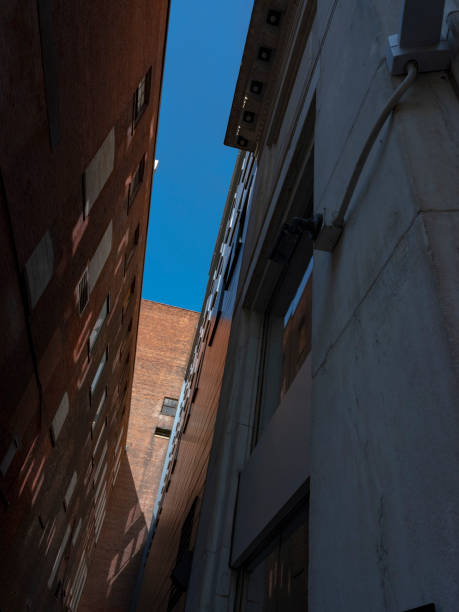 istock V-shaped blue sky between two tall city buildings 1187814382