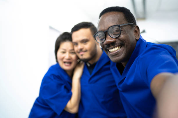 Colleagues taking a selfie in industry Colleagues taking a selfie in industry developmental disability diversity stock pictures, royalty-free photos & images
