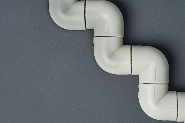 istock Polypropylene, plastic pipeline for water or other liquid lies on dark concrete. Space for text. Top view 1187818095