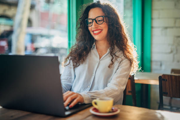 istock Woman using laptop in cafe 1187818405