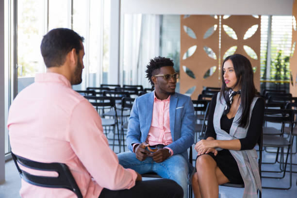 istock Serious coworkers discussing ongoing project together 1187818495