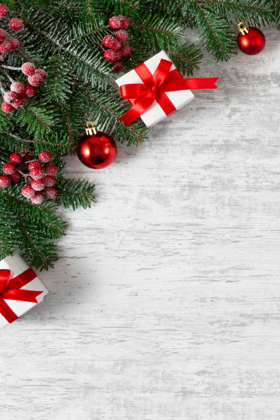 istock Holiday Evergreen Branches and Berries over Wooden Background 1187818556
