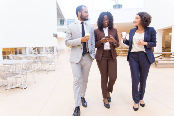 istock Business colleagues chatting while walking 1187822315