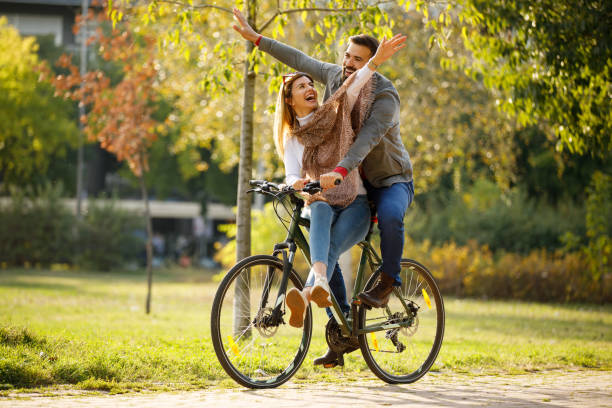 istock Couple enjoying a bicycle ride in the park 1187823864