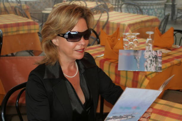 Attractive woman in the restaurant is studying the menu