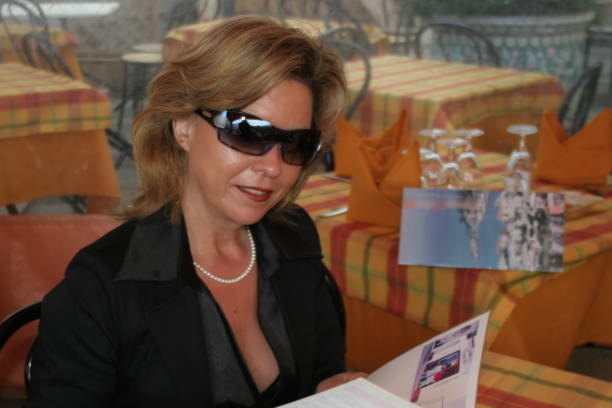 istock Attractive woman in the restaurant is studying the menu 1187823961