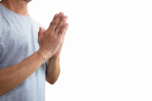 Asian man putting hands together praying isolated on white background with clipping path
