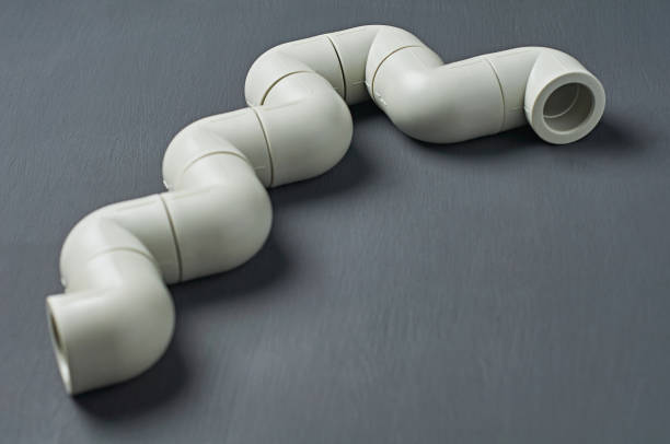 istock Polypropylene, plastic pipeline for water or other liquid lies on dark concrete. Close-up 1187825540
