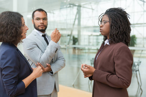 istock Serious multiethnic coworkers discussing project outside 1187826404
