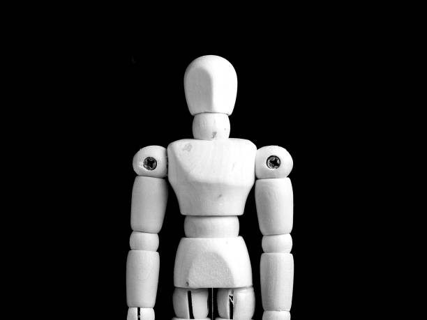 istock a white wooden man doll standing on a black background 1187827429