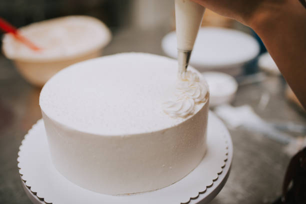 istock White cake decoration, close-up. Pastry chef decorating cake. 1187830887