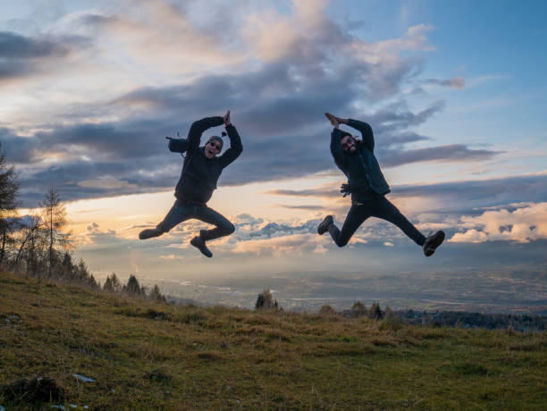 istock Friends jumping on the mountain 1187832740