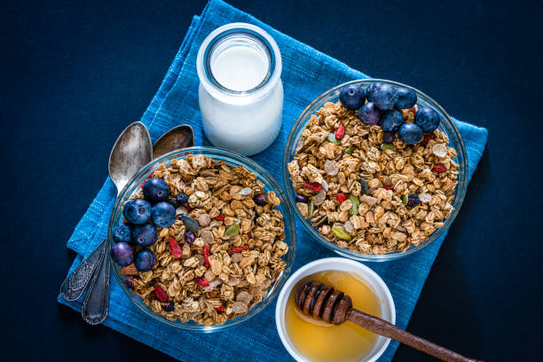 istock Healthy eating: two granola bowls with berries for breakfast. Top view. 1187834824
