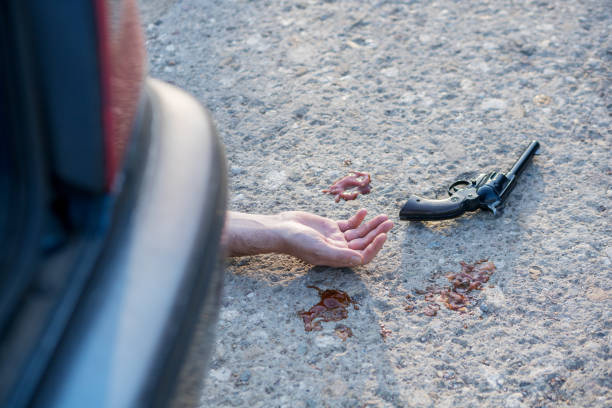 istock gun and hand at murder scene 1187835571