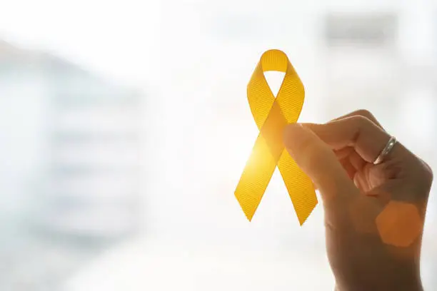 Photo of Close-Up Of Cropped Hand Holding Yellow Ribbon