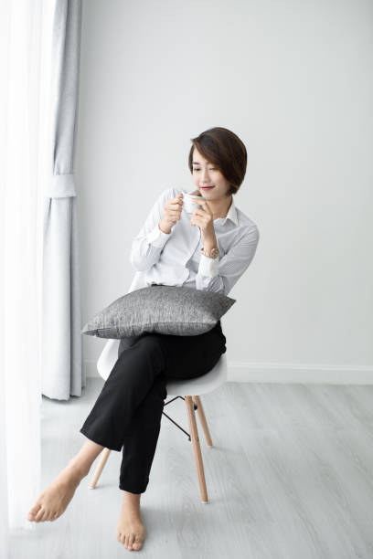 istock Businesswoman drinking coffee and looking out window. 1187838094