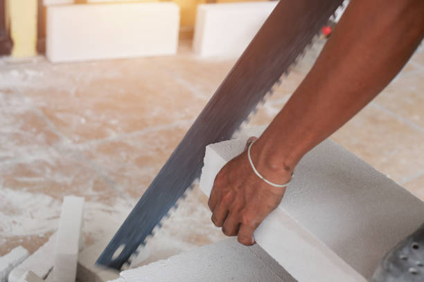 istock Midsection Of Man Cutting Material With Hand Saw 1187838973